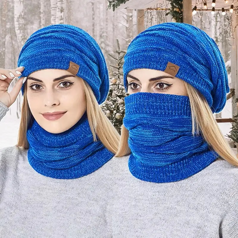Zwei Frauen tragen eine blaue 2-in-1-Sturmhaubenmütze, die Kopf und Hals bedeckt und sich ideal für den Winter im Freien eignet, mit einem verschneiten Walddekor.