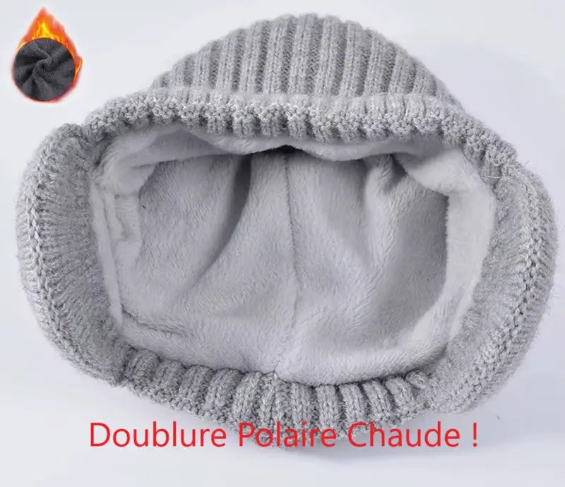 Zoom sur l'intérieur d'un bonnet écharpe enfant en tricot gris, mettant en évidence une doublure polaire chaude et douce, accompagnée du texte 'Doublure Polaire Chaude !' et d'une icÎne de flamme illustrant la chaleur.