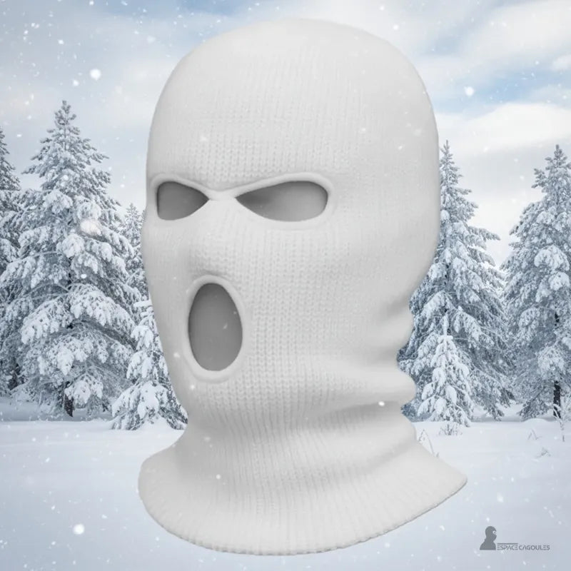 Cagoule 3 trous blanche mise en scène sur fond enneigé de forêt d’hiver pour illustrer chaleur et protection par temps froid