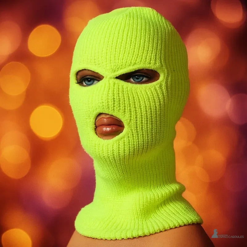 Knitted neon yellow open-mouth balaclava, worn on a mannequin with orange light background, offering visibility and winter protection