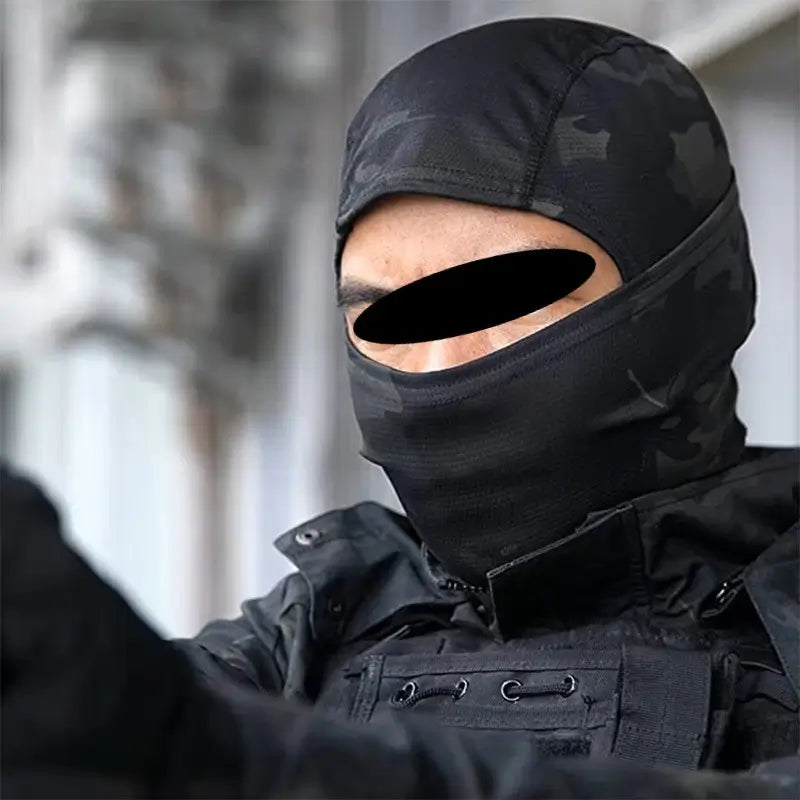 Black military camouflage hood worn by a tactical agent, designed for winter protection.