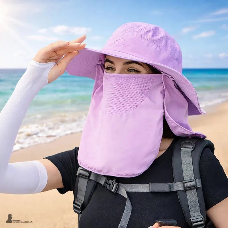 Purple sun protection hood worn on the beach with a face mask and a background of sea and sand - Hood Space