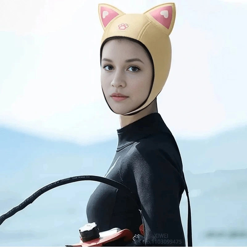 Woman in a wetsuit wearing a yellow humorous diving hood with cat ears. A fun and functional accessory for divers and freedivers.