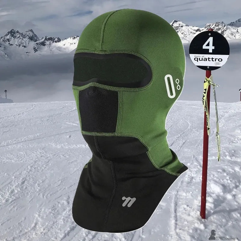 Ski balaclava with a technical stretch fabric and breathable area, full balaclava shape, side view on a snowy mountain slope - Cagoules Space.