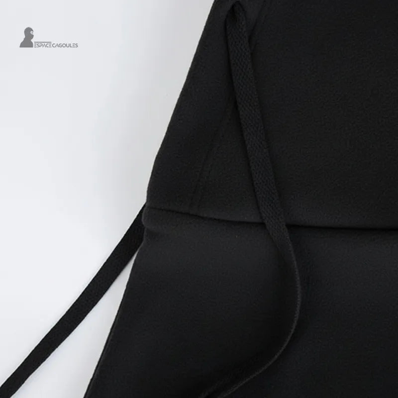 Adult Ski Balaclava over Black Helmet, close-up of the drawstring and the soft texture of the fleece, illustrating the quality finishes.