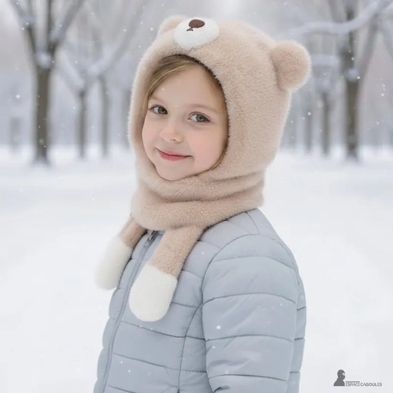 Beige balaclava for children in a wrap-around shape with a lowered face opening, worn by a child outdoors in a winter setting - Espace Cagoules.