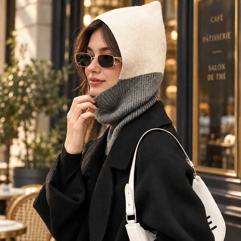 Woman in a black coat and sunglasses wearing the beige and grey Elisa balaclava outside a tea room - Espace Cagoules