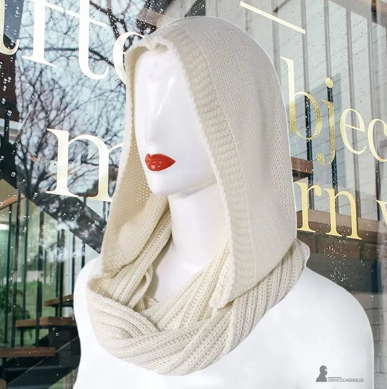 Elegant beige mode kvinnors balaklava i tjock stickning som bärs på en skyltdocka framför ett urbant glasfönster