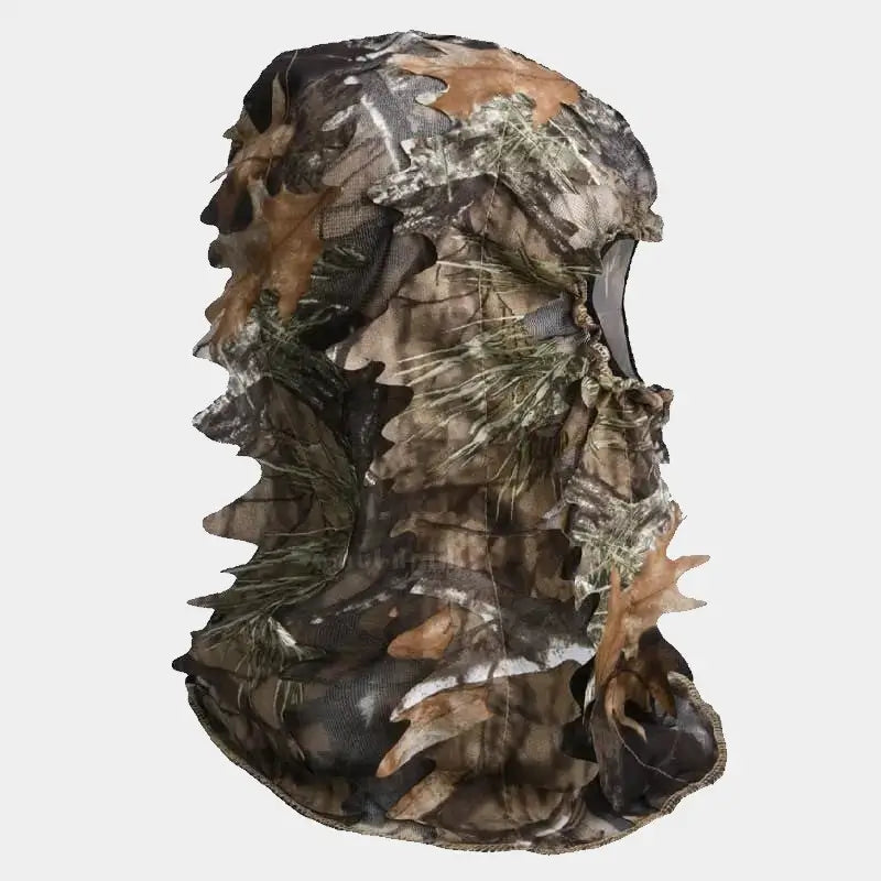 Camouflage net balaclava seen in profile, with a realistic pattern of foliage and branches, providing full coverage for optimal discretion in wooded environments. Perfect for hunting or wildlife viewing.