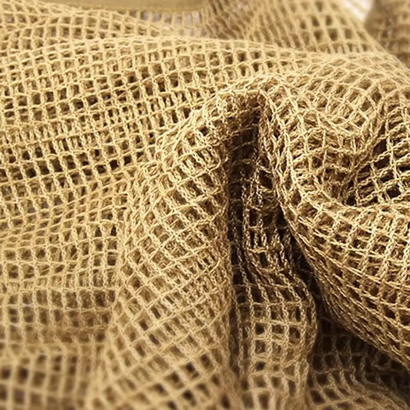 Green camouflage mesh balaclava laid flat, showing off its lightweight and breathable structure.