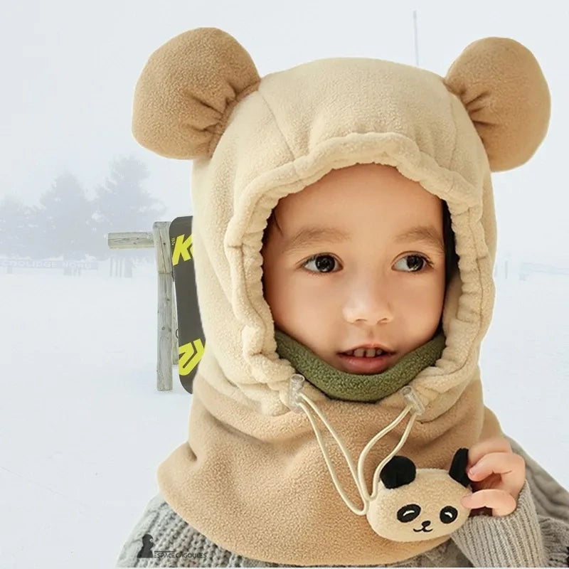 Beige fleece children's very cold balaclava with khaki lining, bear ears and panda décor, worn outdoors in the winter snow.