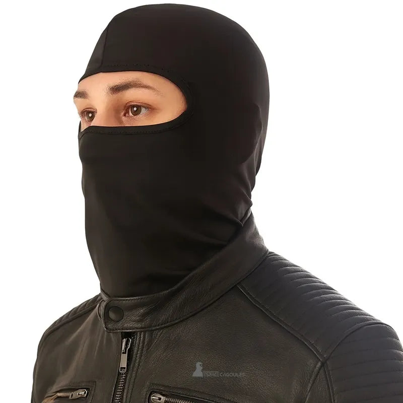 Classic black full body motorcycle balaclava worn by a biker in leather jacket, offering full face and neck protection.