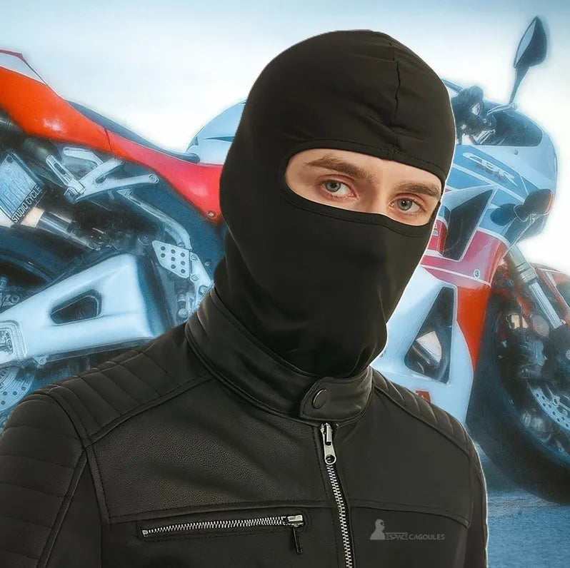 Black motorcycle full body hood worn by a motorcyclist in front of a red and white sports motorcycle, ideal for protection and comfort while riding.