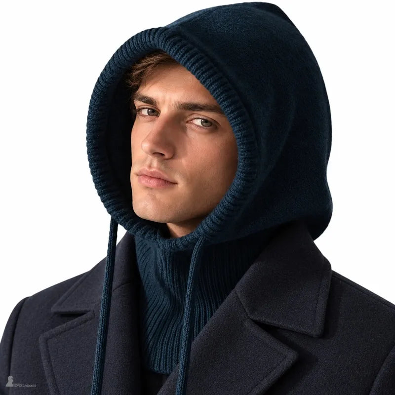 Homme portant la cagoule laine Highland bleu-vert foncé, capuche relevée et col côtelé sur un manteau croisé marine, fond blanc - Espace Cagoules