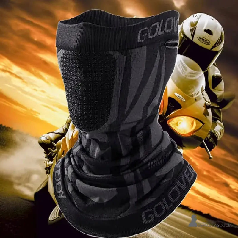 Black motorcycle mask balaclava with facial ventilation, against the background of the sunset, worn by a motorcyclist in the middle of a race