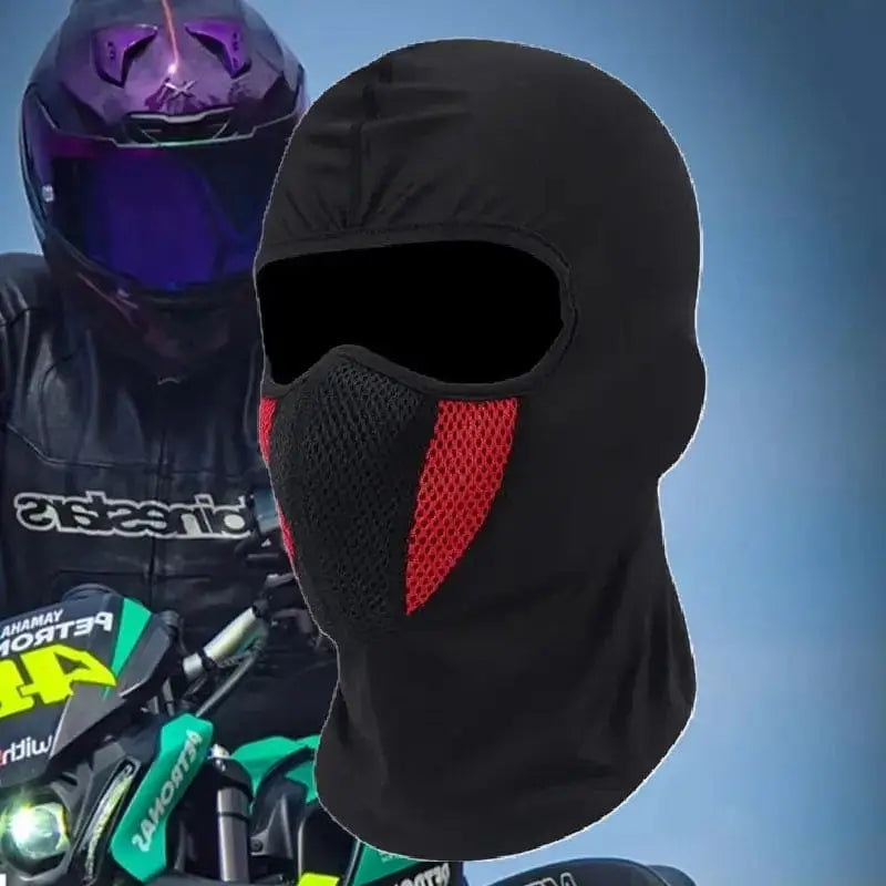 Black and red Lycra motorcycle balaclava worn by an equipped biker, helmet with purple reflections in the background. Full face protection with breathable mesh area.