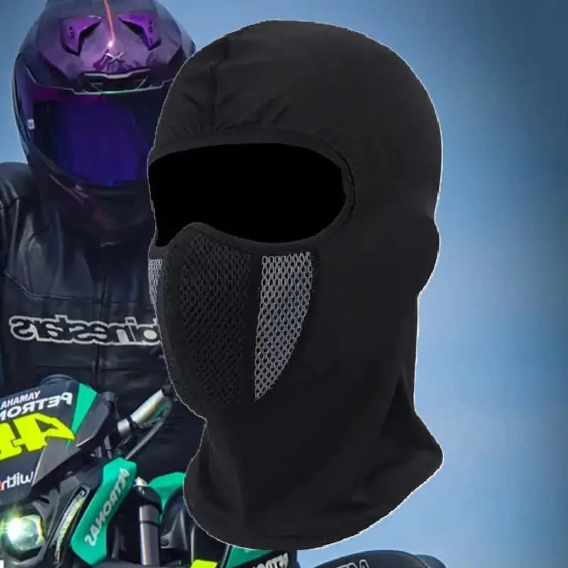 Lycra motorcycle balaclava worn by an equipped motorcyclist, helmet with purple reflections in the background. Full face protection with breathable mesh area for better comfort and ventilation.