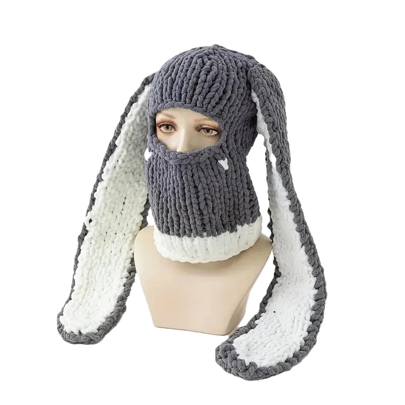 Grey and White Rabbit Ears Balaclava on Mannequin â A warm dark grey wool balaclava with rabbit ears lined with white fleece is displayed on a mannequin, against a contrasting black background.
