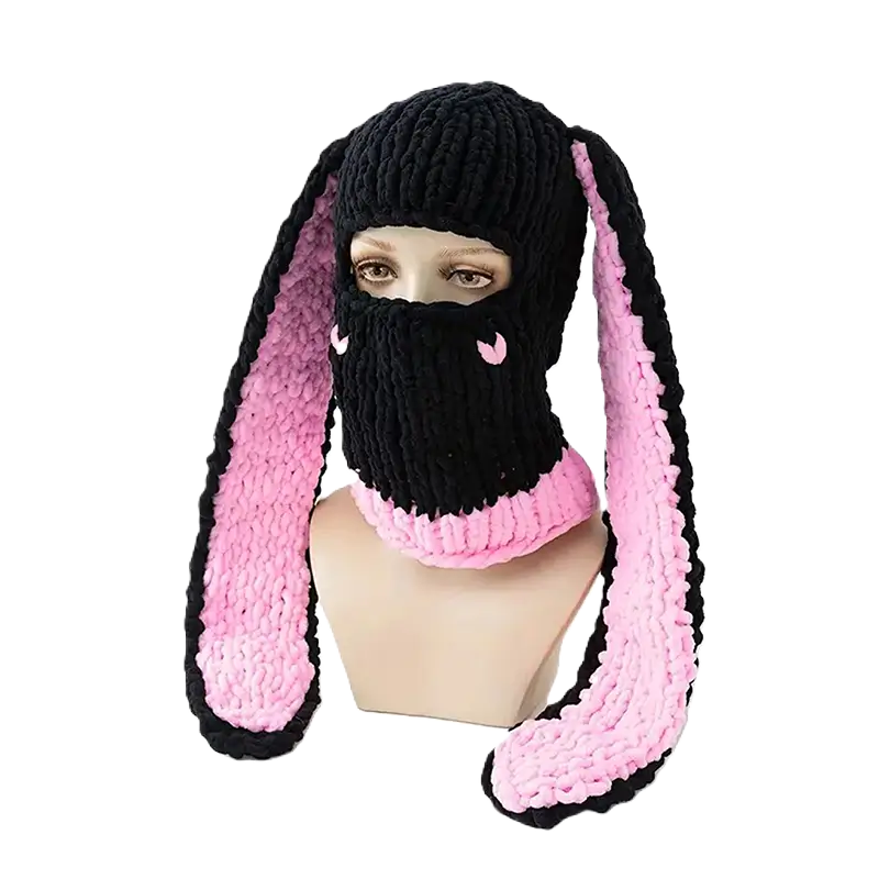 Black and pastel pink rabbit ears balaclava on mannequin â A black female balaclava with pastel pink faux fur bunny ears. Presented on a mannequin, it combines comfort and unique style.