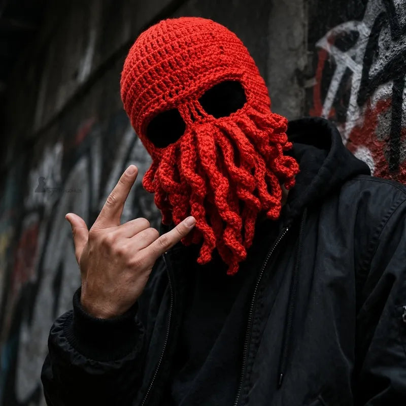 Person wearing a red knitted octopus hood in an urban environment with a dark jacket - Hood Space