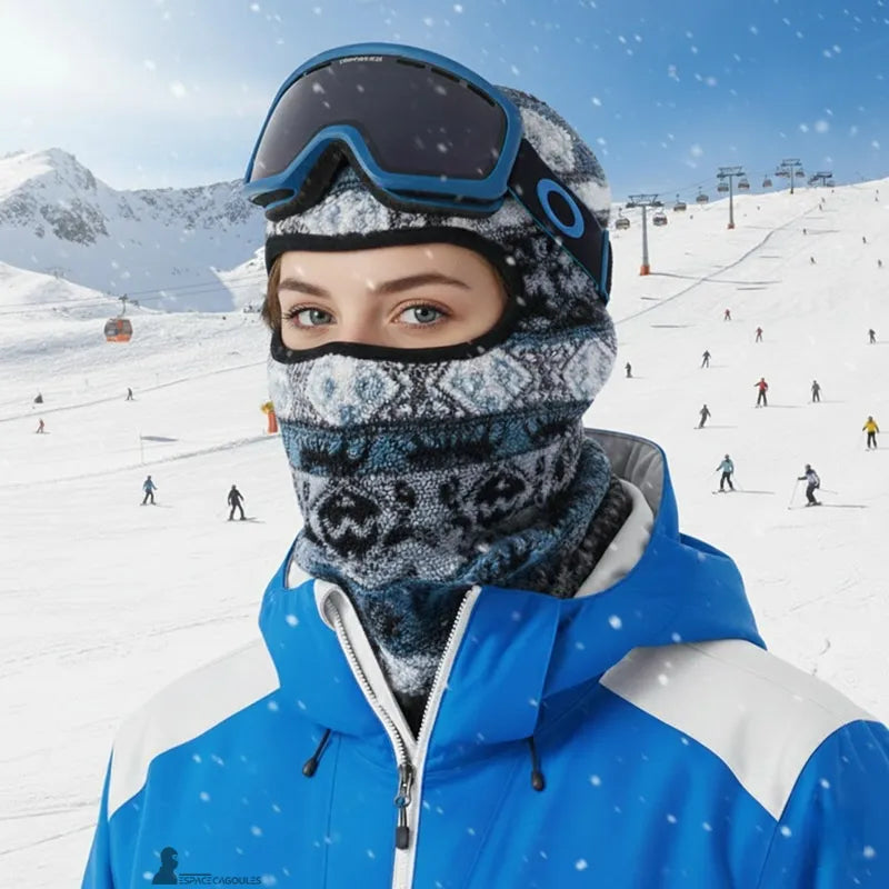 Ski hood worn by a woman on a snowy slope with a helmet and mask showing a comfortable fit and protection for the face and neck - Space Hoods.