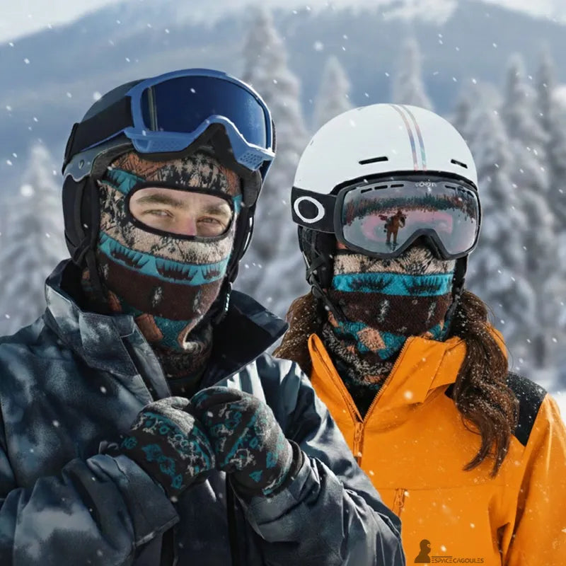 Ski hood worn by a man and a woman in a snowy mountain environment with helmet and mask showing complete face protection against the cold - Hood Space 6. Visual worn by a woman on the ski slope.