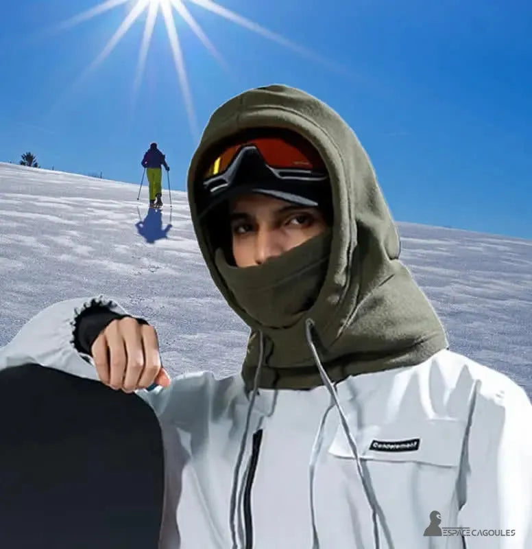 Cagoule snowboard polaire chaude et protectrice portée par un snowboarder sur piste enneigée en plein soleil