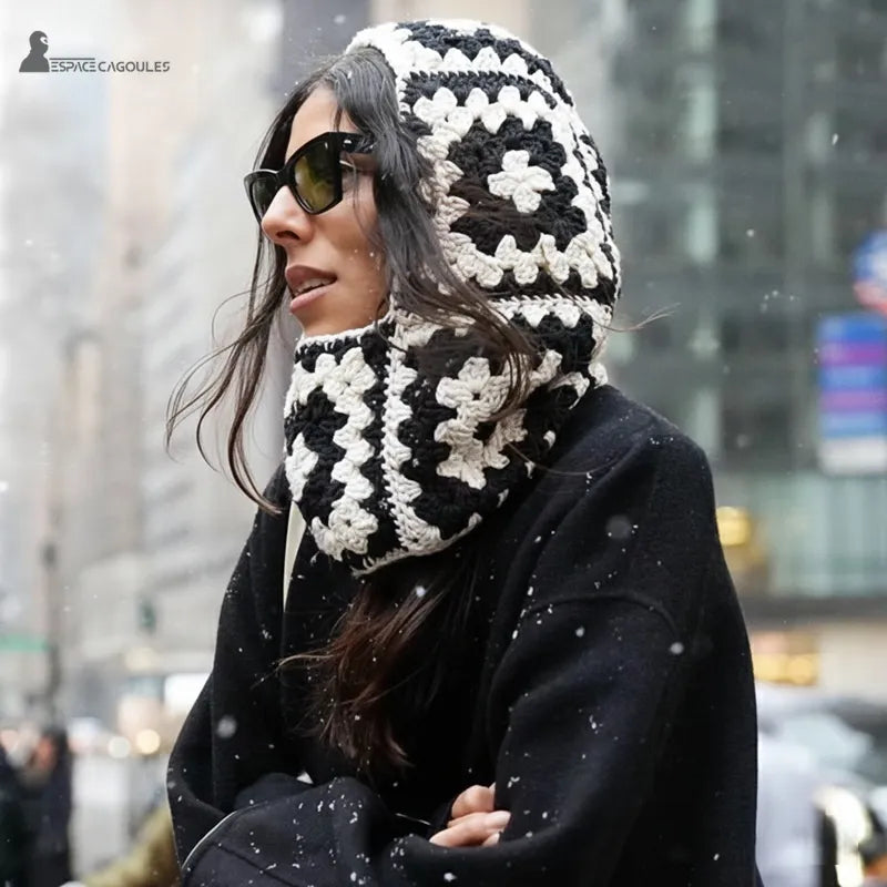 Balaclava neck strap woman crochet black and white back view worn with black coat outdoors under the snow