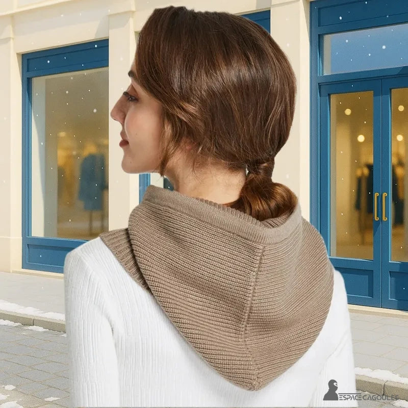 Camel women's knitted balaclava seen from the back outside, glass shop background with falling snow