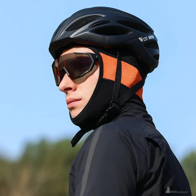 Black and orange silk bike balaclava worn under helmet with glasses, cyclist ready to ride
