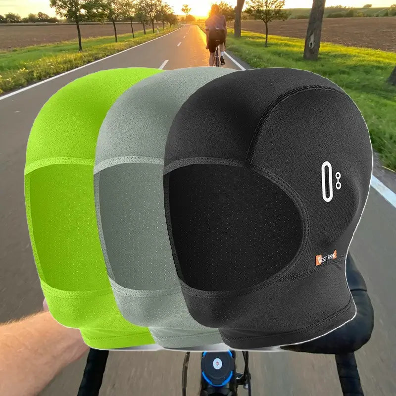 Cagoule vélo été minimaliste en plusieurs couleurs (noir, vert, gris), posée sur un support extérieur. Légère et respirante pour cyclisme estival.