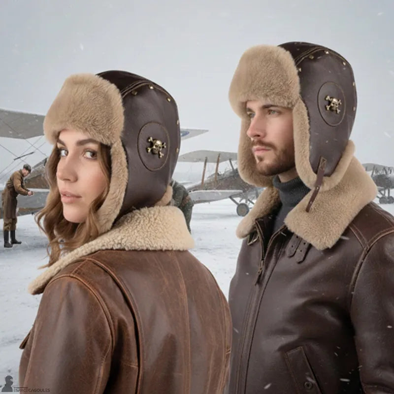 Chapka aviateur en cuir marron et fausse fourrure portée par une femme et un homme, vue de trois quarts, décor hivernal avec avions anciens - Espace Cagoules