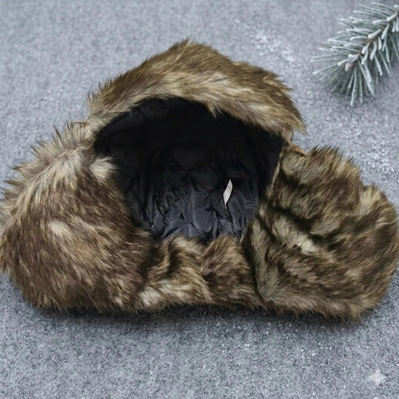 Brown and beige faux fur chapka with black quilted interior, top view placed on a gray surface – Cagoules Space