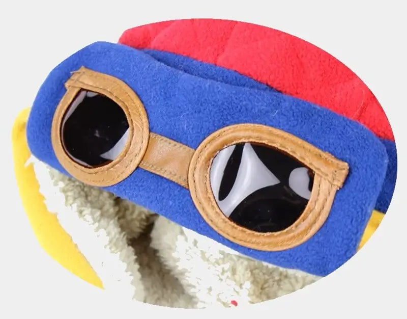 Close-up of the brown plastic glasses of a blue and red aviator hat, sewn securely on the hat.