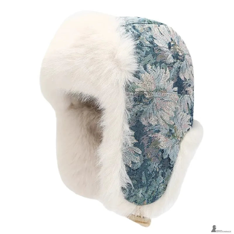Vue de profil d’une chapka florale bleue avec bordure en fourrure blanche et finition épaisse - Espace Cagoules