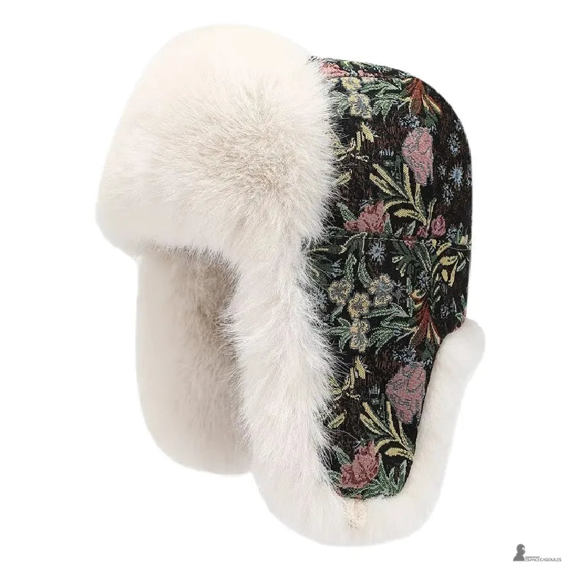 Chapka noire à motif floral coloré avec fourrure blanche et rabats oreilles vue de côté - Espace Cagoules