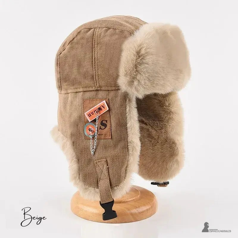 Women's winter hat beige model displayed on wooden support with lined interior