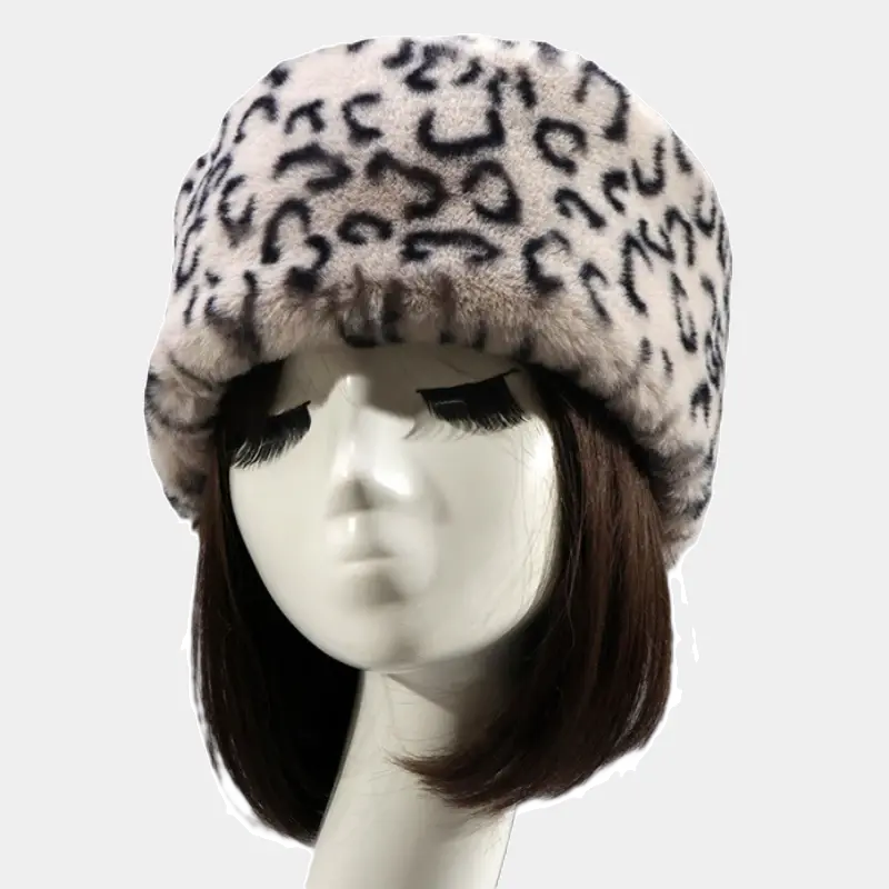 Ivory leopard hat with black faux fur print, on mannequin. A warm and trendy hat for winter.