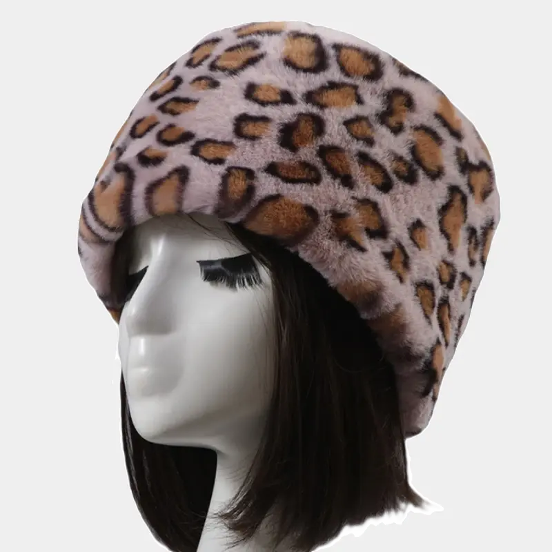 Pink leopard hat in faux fur, original animal print on a pastel background. Chic and comfortable accessory for winter.