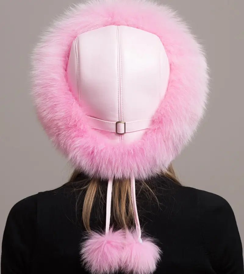 Rückansicht einer russischen Chapka aus echtem rosa Pelz, mit weißem Ledersockel und Kordeln, die mit einem passenden Fellpompon verziert sind. Schlankes und funktionales Design für optimale Wärme im Winter.