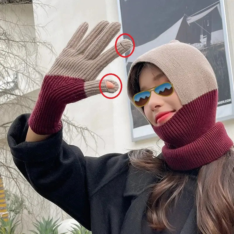 Smiling woman wearing a two-tone balaclava in beige and burgundy wool matched with wool gloves. Women's wool gloves have tactile finger zones, ideal for practical use with screens in winter.