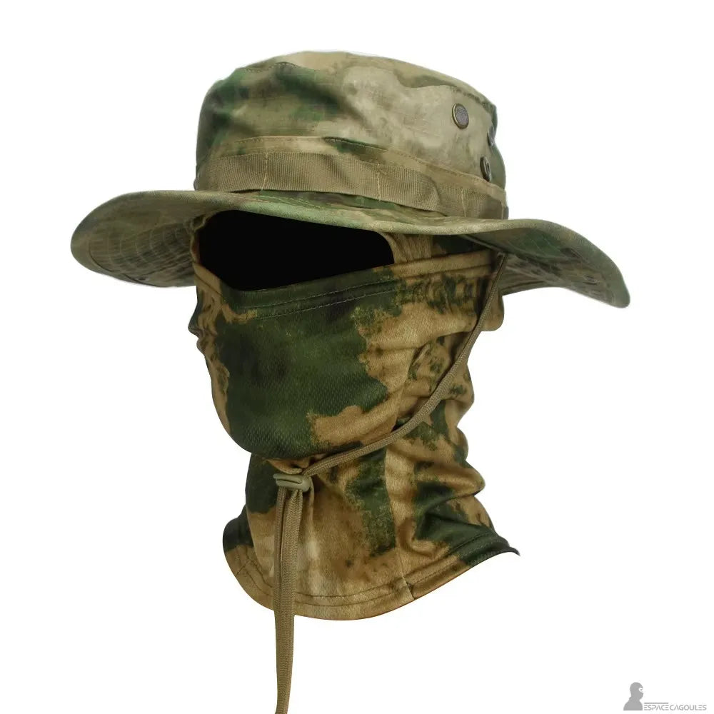 Green and beige camouflage balaclava hat with A-T pattern in profile view, featuring a wide brim and integrated face protection on a white background - Space Balaclavas.