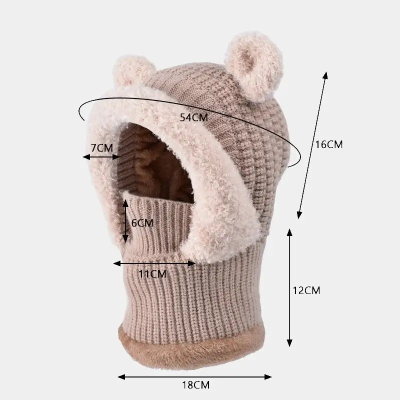 Cagoule enfant fille beige illustrée avec des dimensions détaillées, montrant un design pratique avec un col montant et des oreilles d'ours.