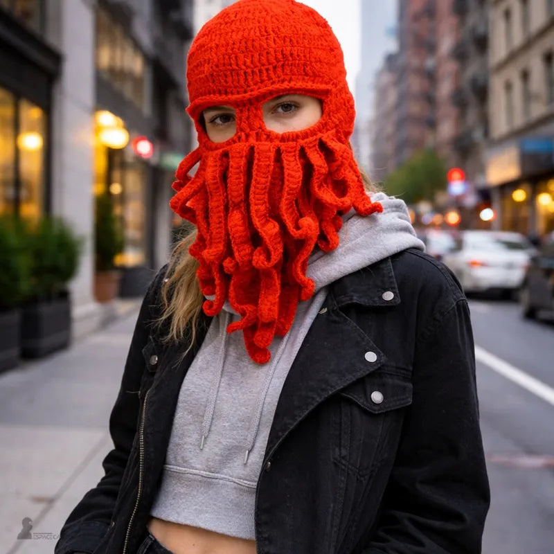 Person wearing a red knitted octopus hood in a street with a jacket and hood - Hood Space
