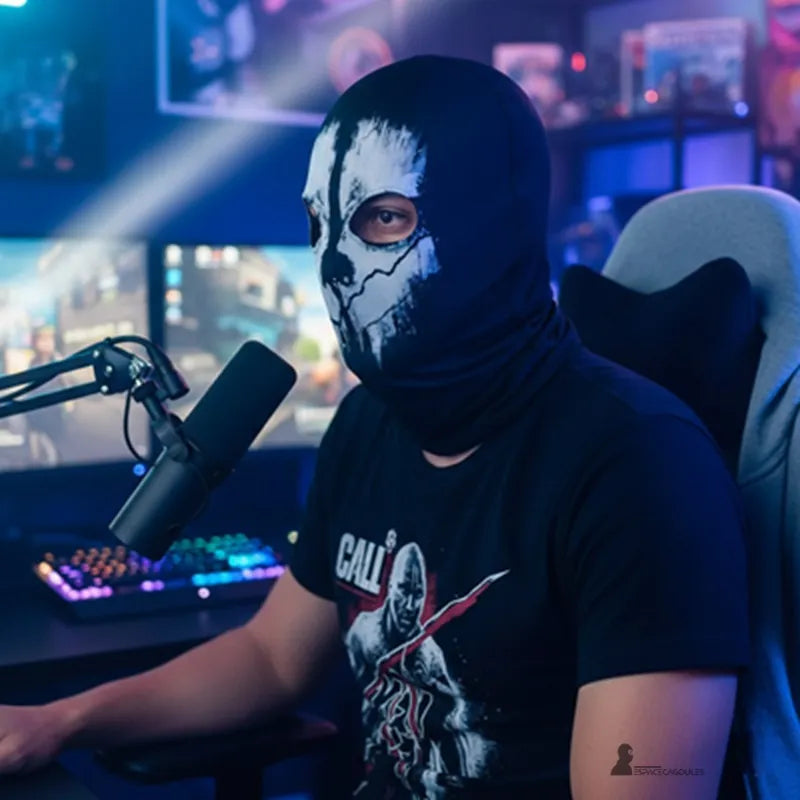 Black Skull balaclava worn by a man sitting in front of a screen and a microphone in a bright gaming environment – Balaclava Space