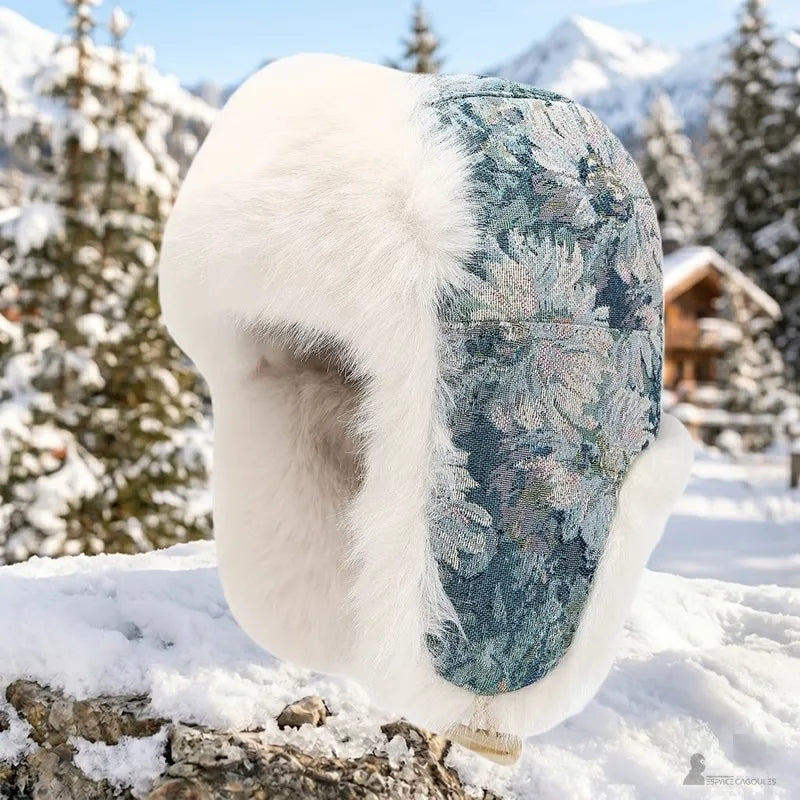 Chapka Femme à motif floral avec fourrure blanche épaisse et rabats oreilles, posée sur neige en extérieur - Espace Cagoules